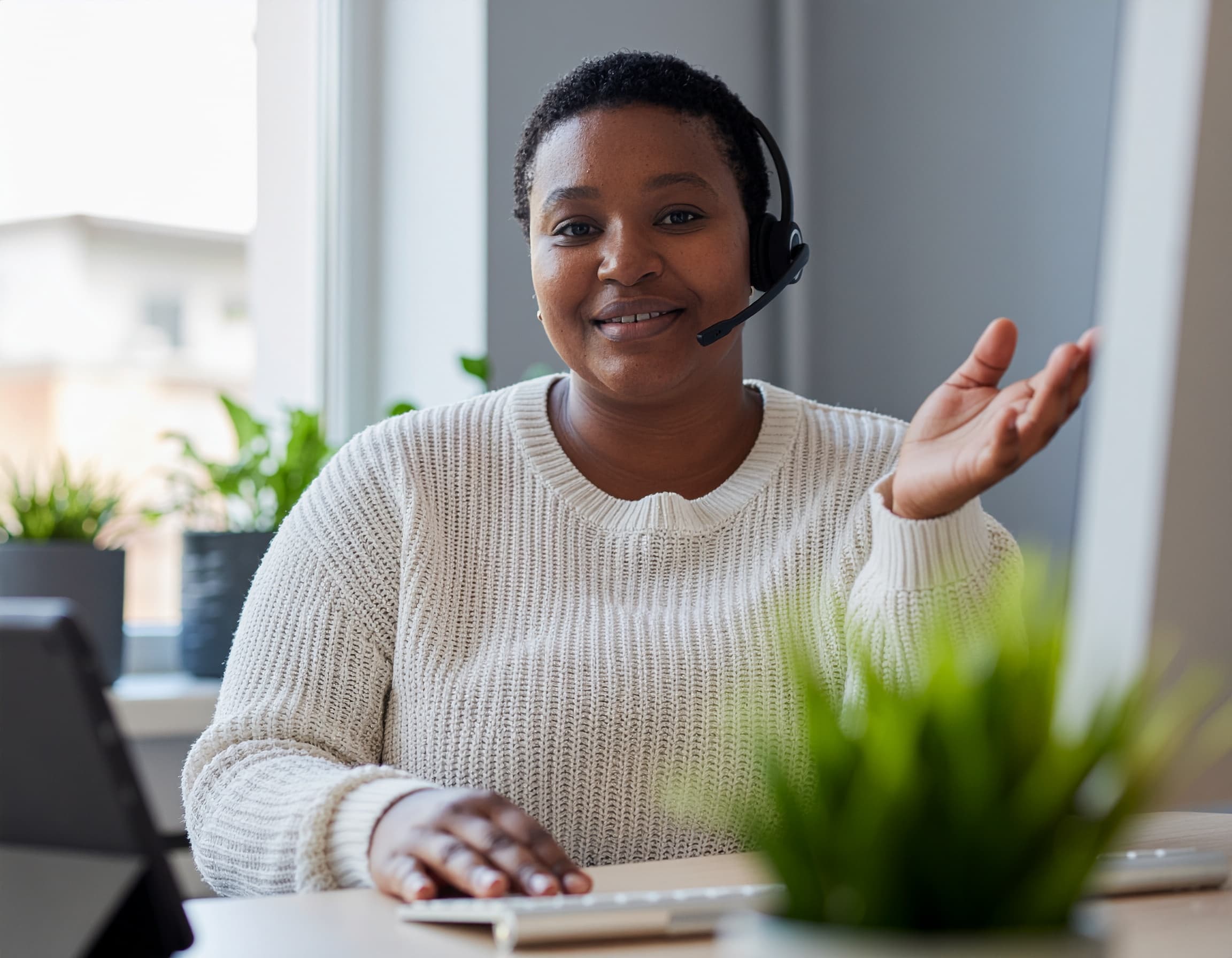 A case manager on a call at her desk